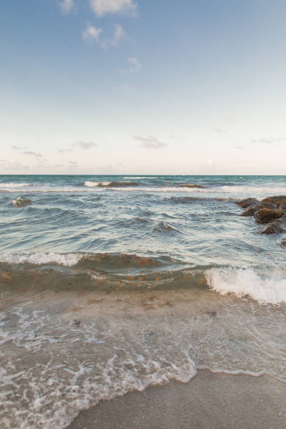 istock Teal Beach Waves on a Rocky Shoreline in Boca Raton, Florida 1329409908