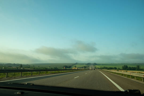 istock Asphalt highway in the fog. 1329411966