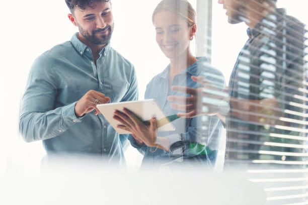 istock Business team looking at a digital tablet. 1329415276