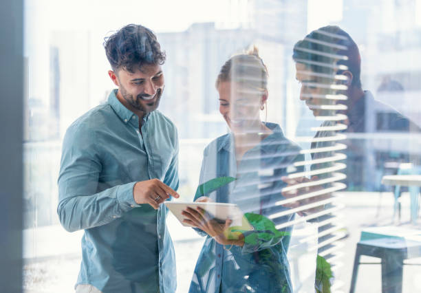 istock Business team looking at a digital tablet. 1329415277
