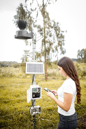 woman checking weather station
