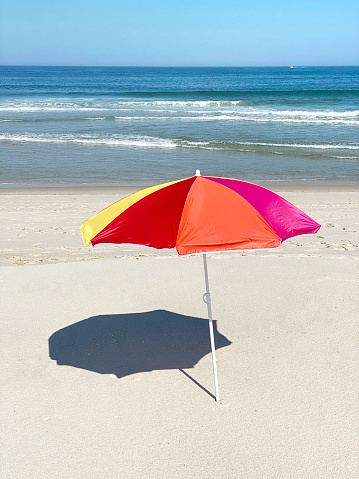 Close up of a rainbow colored umbrella.