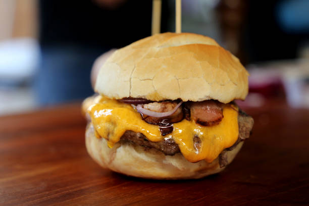 istock hamburger with cheese, tomato and bread made in barbecue grill. Side view. Close up 1329417824