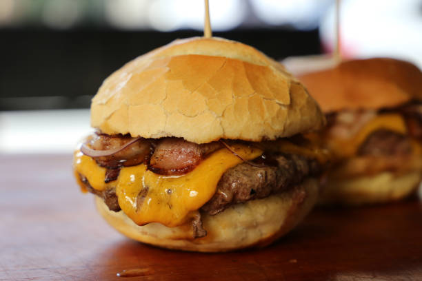 istock hamburger with cheese, tomato and bread made in barbecue grill. Side view. Close up 1329417839