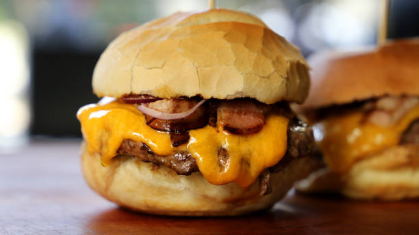 istock hamburger with cheese, tomato and bread made in barbecue grill. Side view. Close up 1329418031