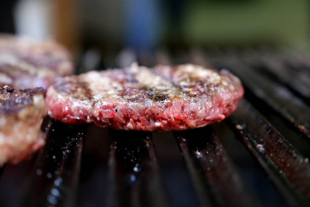 istock hamburger on the parrilla grill with grill marks 1329418041