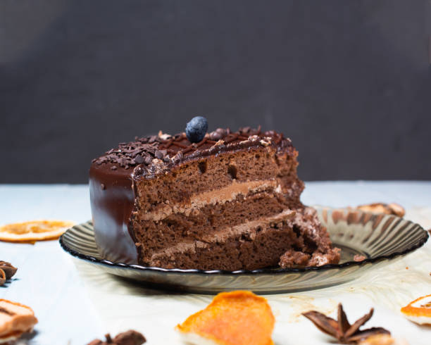 istock slice of chocolate cake with blueberries on top on gray background 1329418113