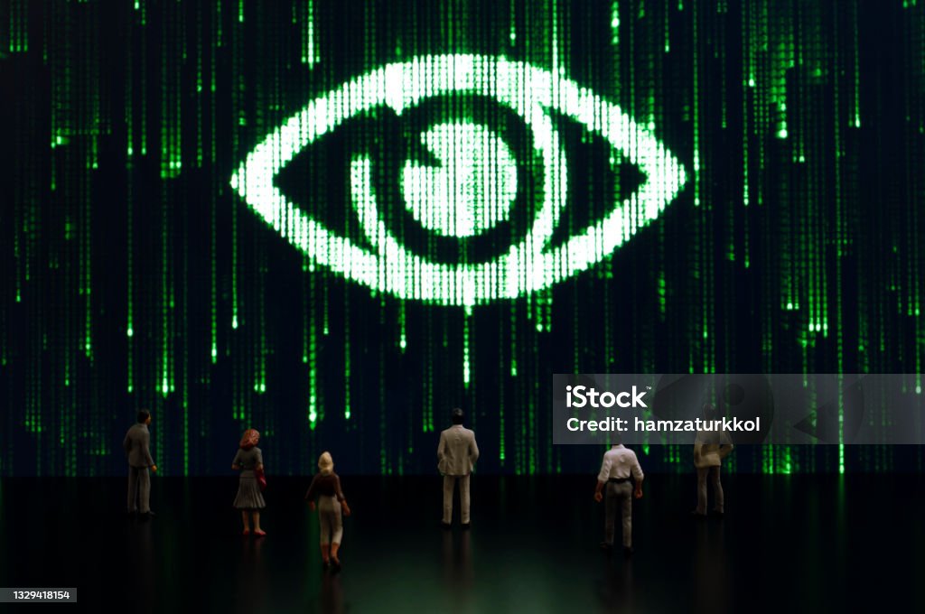 Matrix: Big brother is watching you Businessman/politician figurines examine a matrix style eye. Artificial intelligence/technology/digital age concept Surveillance Stock Photo
