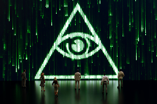 Businessman/politician figurines examine a matrix style illuminati symbol. Artificial intelligence/technology/digital age concept