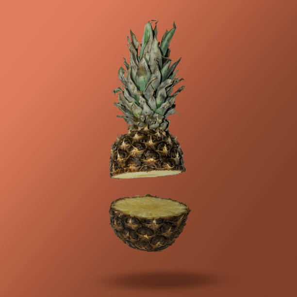istock Sliced pineapple floating in the air on trendy pantone rust background 1329419670