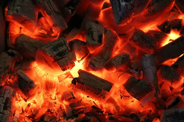 Photo of glowing coal in a barbecue in brazil. close up