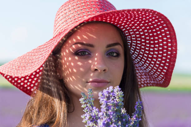 A beautiful woman walks in a field of lavender.