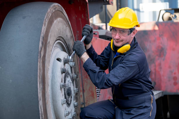 istock Cargo container technician or worker use wrench to fix problem about truck tire and also look at camera 1329430961
