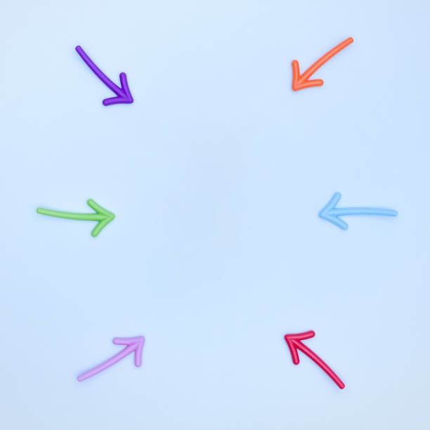 istock Multi-colored arrows pointing to the area between them on a light blue background. 1329434025