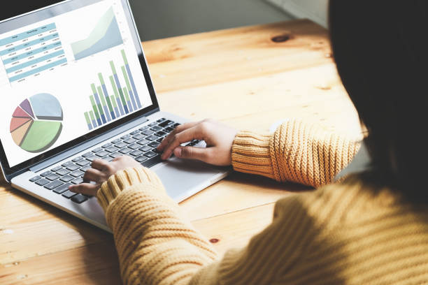 istock A female employee using computer to check the company's investment budget. 1329434076