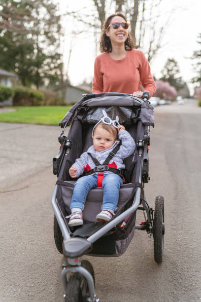 istock Beautiful Ethnic Mother Pushing Toddler In Stroller 1329435477