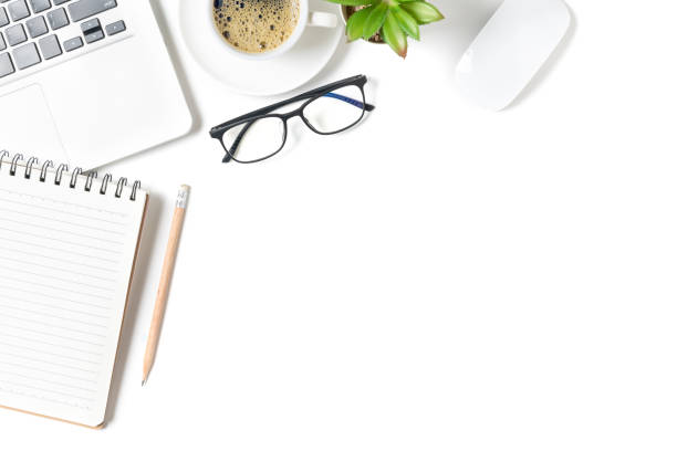 istock White office desk table, Blank notebook with laptop and hot coffee. 1329437075