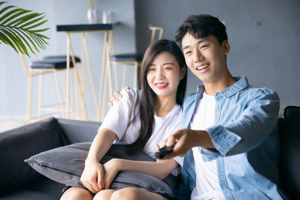 istock Couple watching TV at home 1329442712