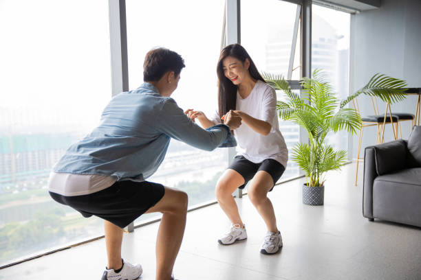 istock Couple exercising together at home 1329442802