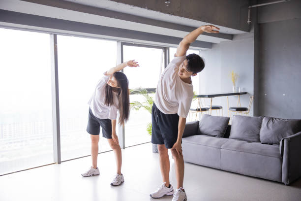 istock Young couple exercising together 1329442823