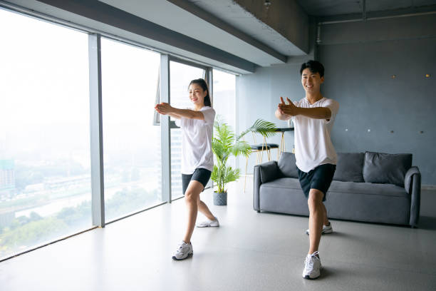 istock Young asian couple exercising together 1329442856