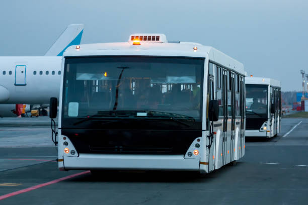 istock Two airport shuttle buses at the morning airfield 1329443671