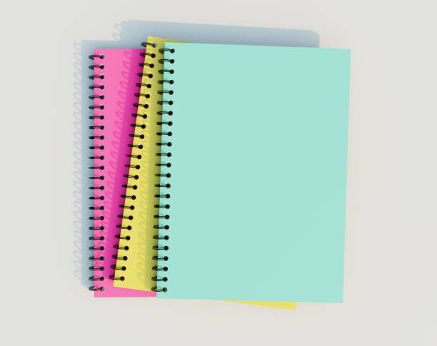 Stacked spiral binder notebooks. Blank colourful notebooks. Top view.