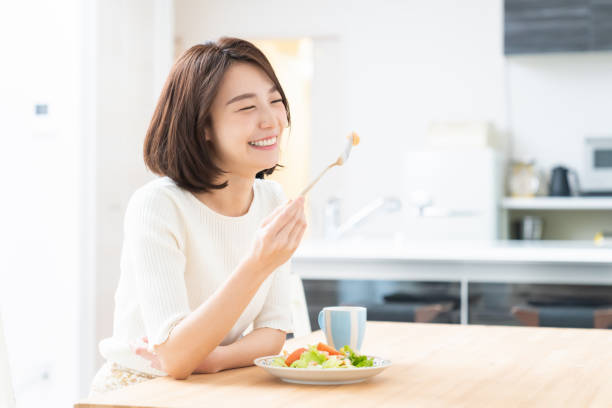 attractive asian woman who eats stock photo