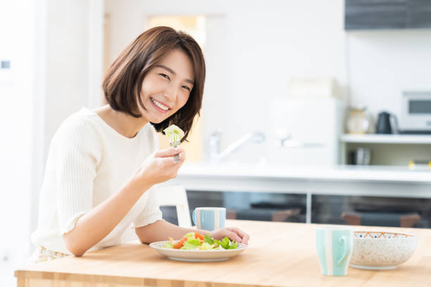 istock attractive asian woman who eats 1329445533