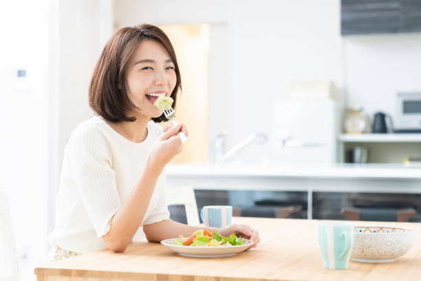 istock attractive asian woman who eats 1329445610