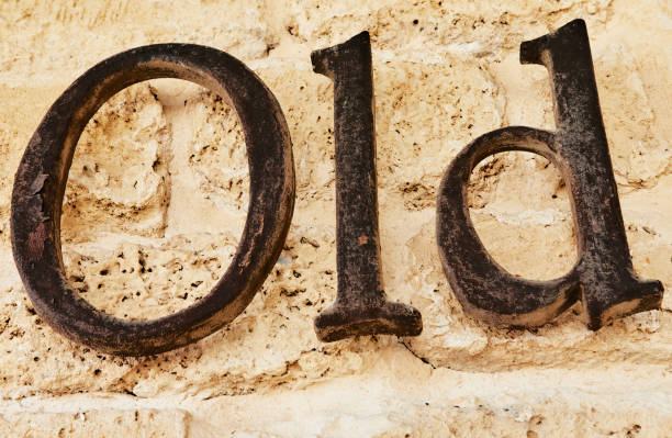 The word old in metal letters on stone background