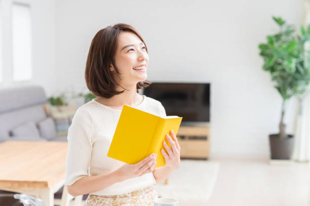 istock attractive asian woman who reads a book 1329445743