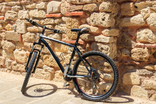 istock Bicycle leaning against the old stone wall 1329446409