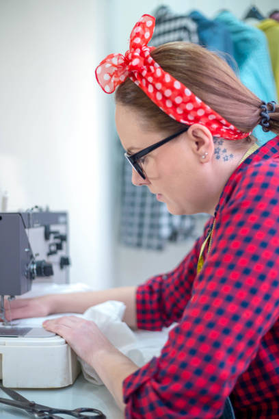 istock Young fashion designer working with a sewing machine 1329447130
