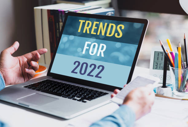 Trends for 2022 or business  creativity with text and young person using conputer.