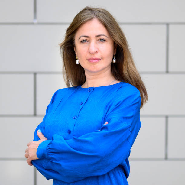 istock Serious resolute stylish professional woman with folded arms 1329448007