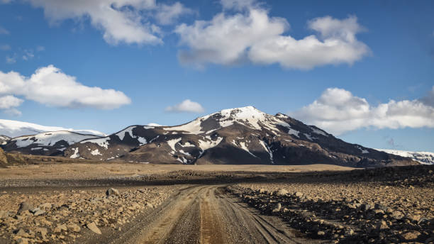 Iceland Gravel Dirt Road Panorama Langjökull Glacier Geitlandsjökull Empty Iceland Gravel Country Road along the Langjökull Glacier and Geitlandsjökull Mountain Range under summer skyscape with fluffy clouds. Off Track F-Road along Langjökull Glacier, Husafell, Western Region Iceland, Iceland, Nordic Countries, Northern Europe icecap photos stock pictures, royalty-free photos & images