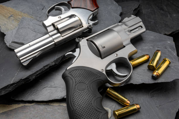 istock Revolver handguns on black stone background 1329452676