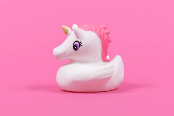 istock Cute rubber duck unicorn on pink background 1329452687
