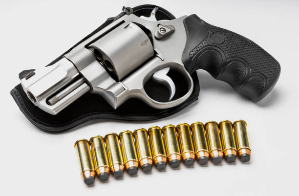 istock Revolver gun and .44 bullets on white background 1329452706