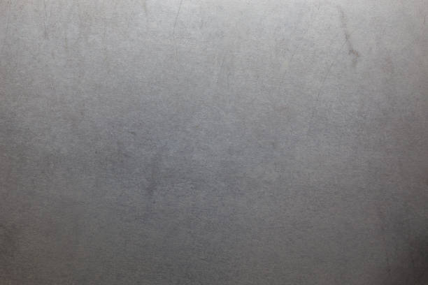 Uncoated flat cold rolled steel sheet surface with few minor scratches. Close-up in directly above composition.