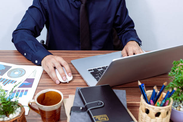istock Business people use computers to work at their desks 1329455485