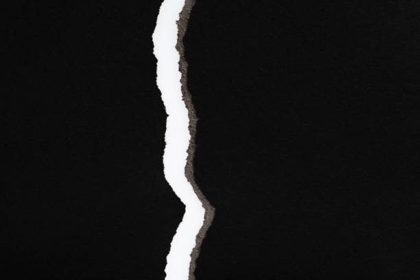 istock Background of torn black paper 1329455617