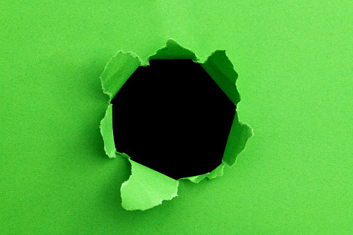 Green paper with a round hole.