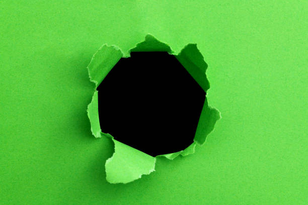 green paper with a round hole - two dimensional shape paper exploding nobody imagens e fotografias de stock