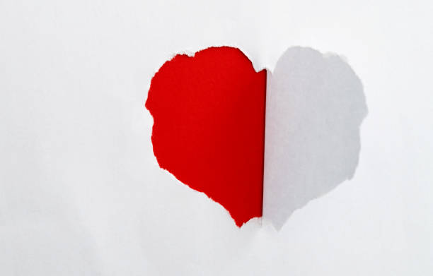 istock White paper with a heart shape hole 1329455732