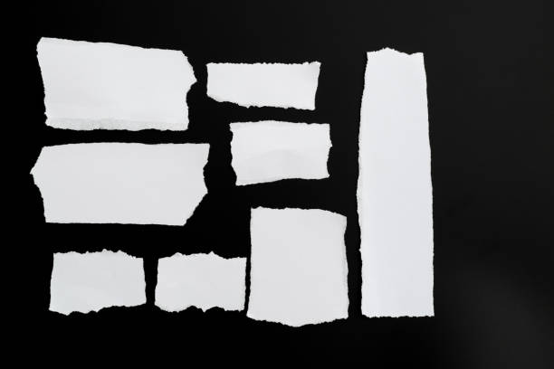 клочки бумаги на черном фоне - cut or torn paper tearing torn paper стоковые фото и изображения