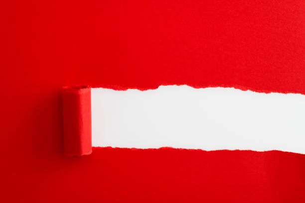 istock Red paper tearing a hole 1329455896