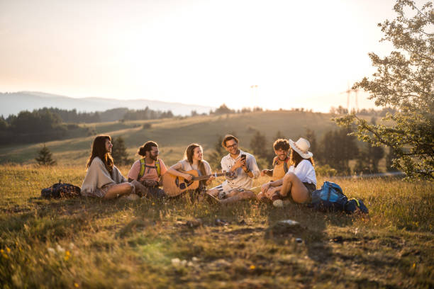 istock Happy hikers enjoying in guitar music on a hill. 1329456710