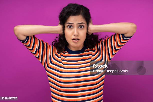 Portrait Of Young Women Standing Isolated Over Purple Background Stock Photo - Download Image Now